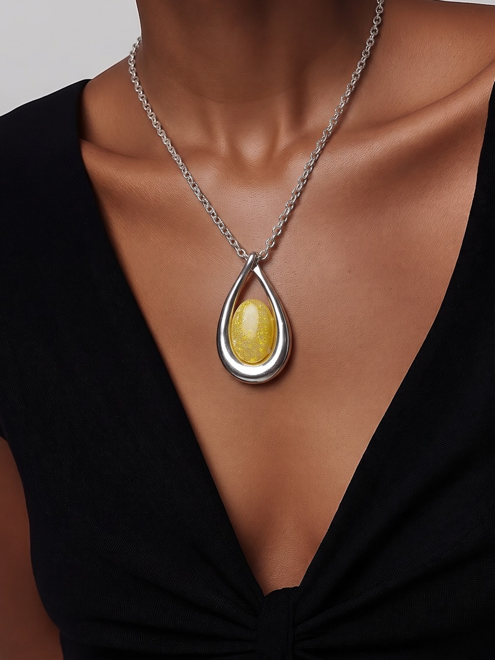 Kenneth Cole Silver Teardrop Pendant
Necklace with Yellow Glitter Stone
